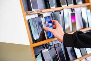 Hand reaching for a smartphone