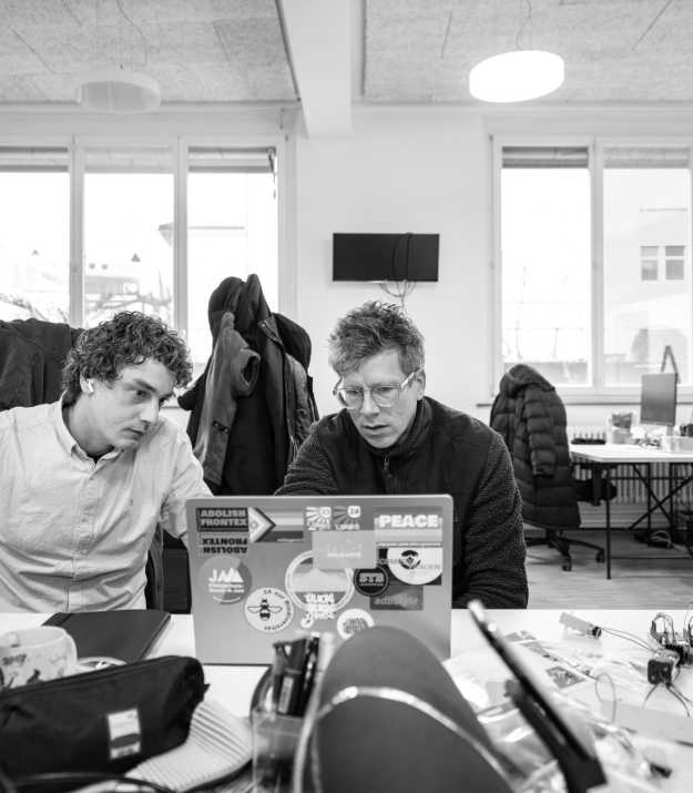 Corsin and Adrian look at a laptop together