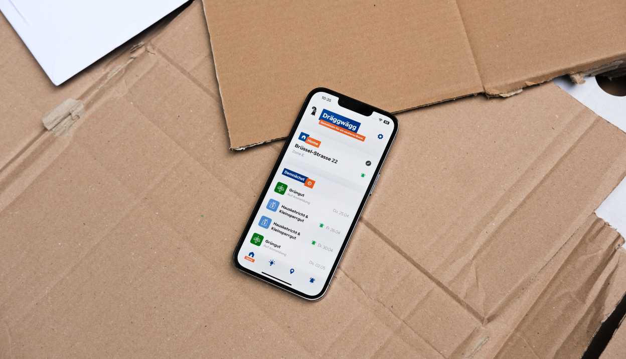 Dräggwägg app open on an iPhone lying on cardboard.
