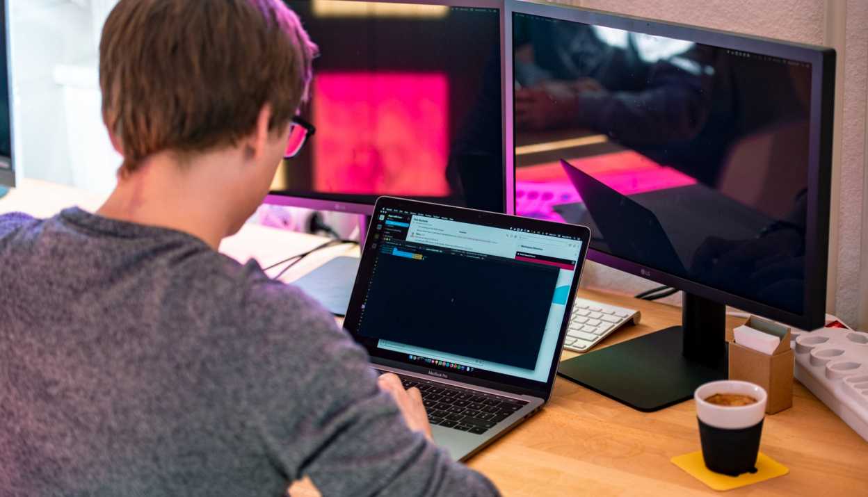 web developer is coding on his workplace at Apps with love