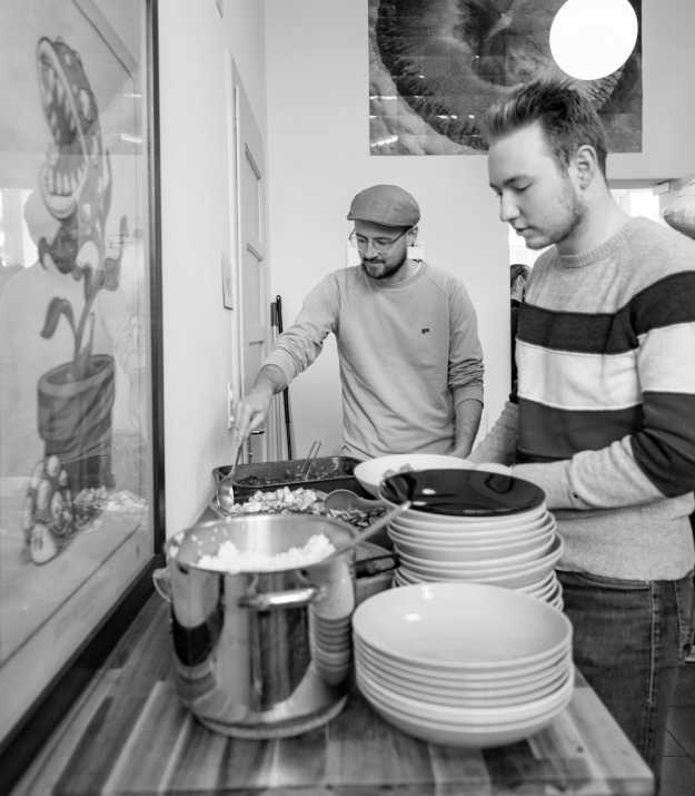 Stefan and Alain getting lunch in the kitchen