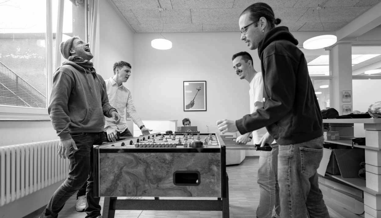 4 people playing table football