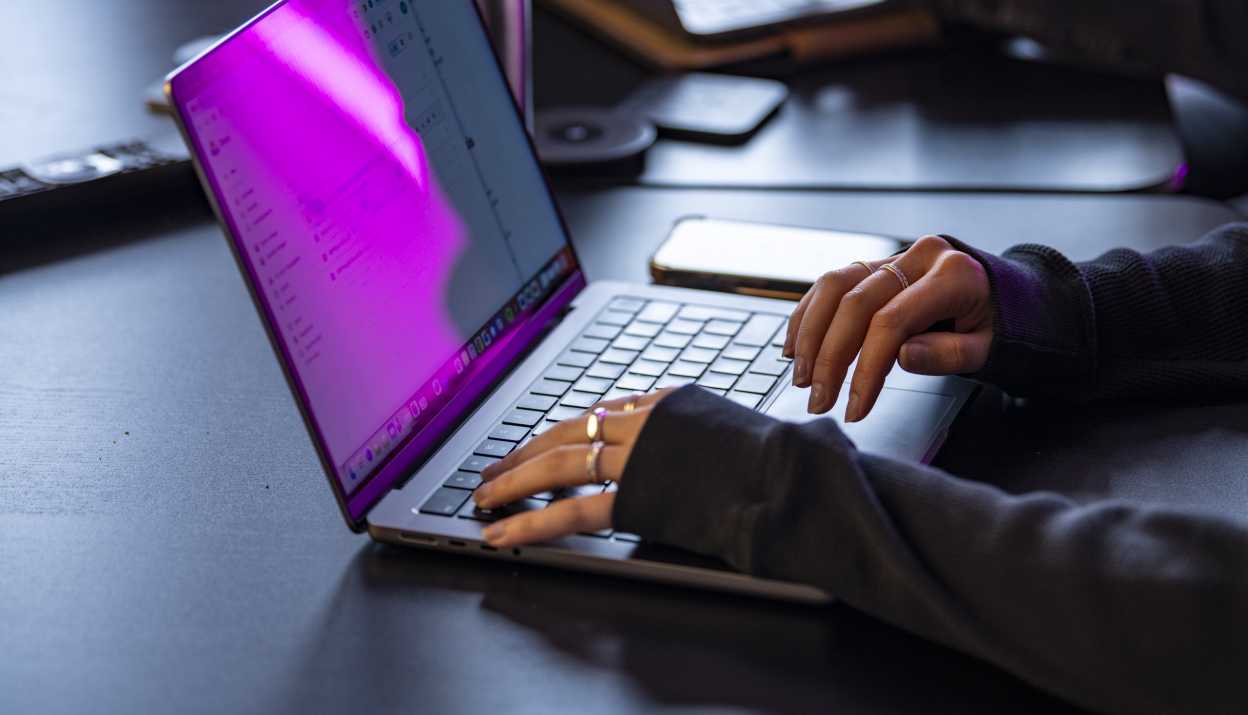 Close-up of someone typing on a laptop